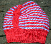 Striped hat with cable shown in Ravelry Red