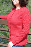 Malabrigo Worsted Merino Yarn, color ravelry red #611,  cabled cardigan